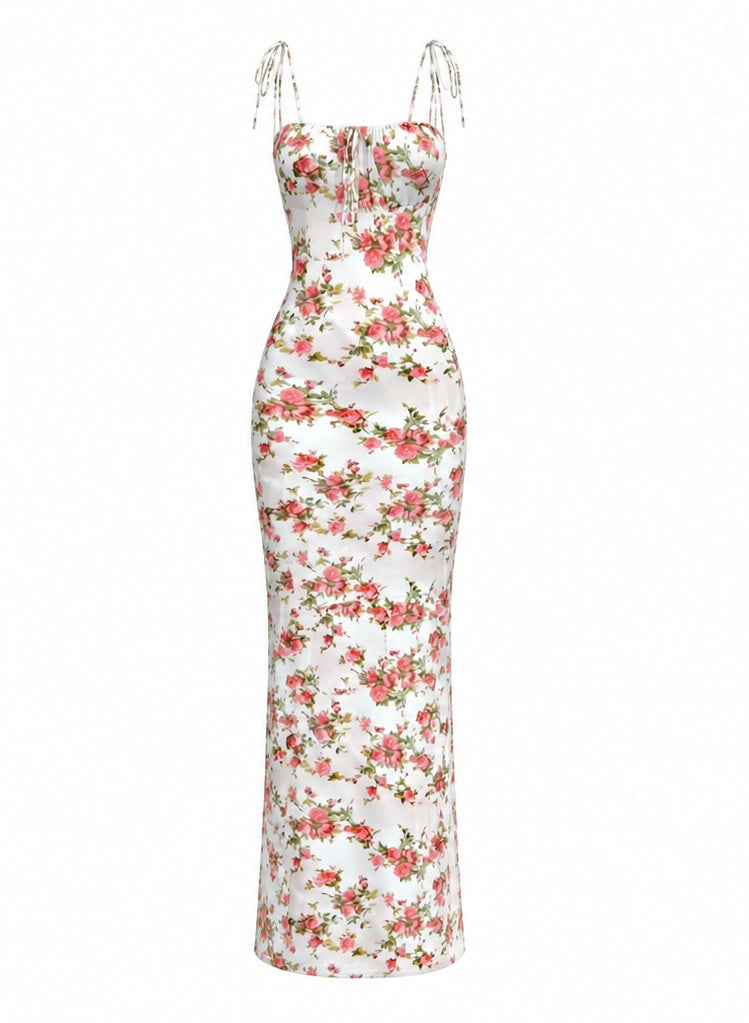 A sleeveless white maxi dress with a red and green floral print, featuring thin shoulder straps and a fitted silhouette.
