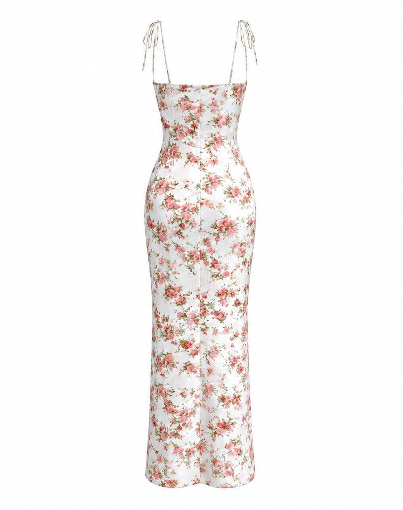 A white satin slip dress with a pink and green floral print, featuring thin adjustable tie-shoulder straps, shown against a plain white background.