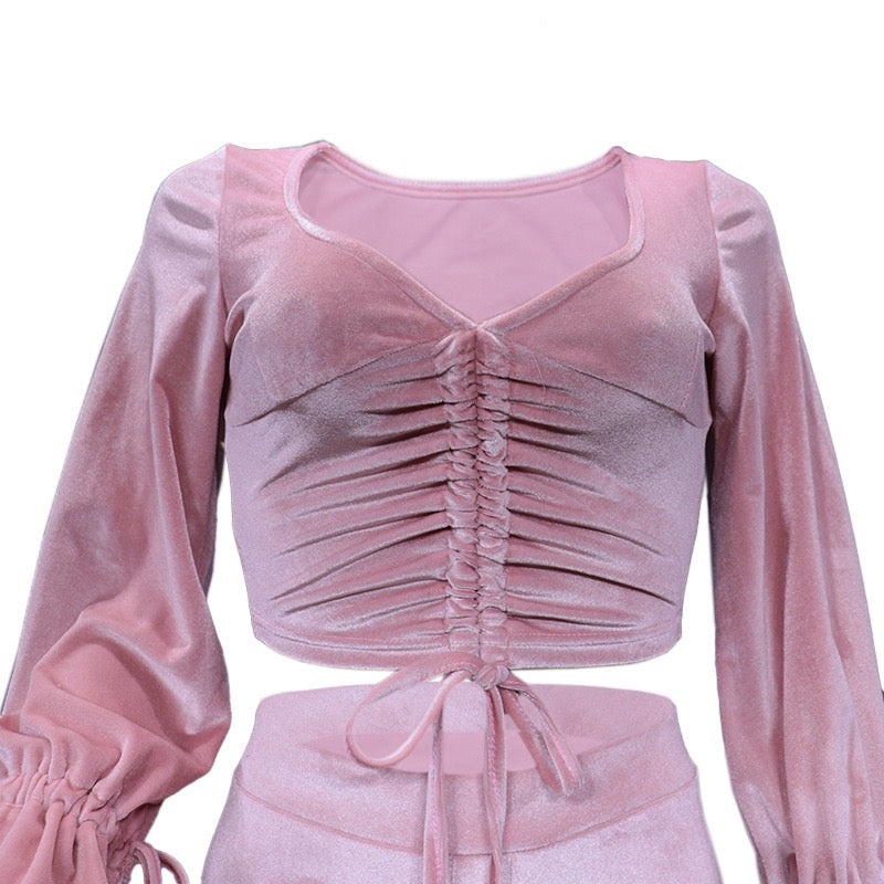 Pink velvet top with long sleeves on a white background