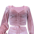 Pink velvet top with long sleeves on a white background