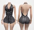 Black and white polka dot one-piece swimsuit shown on a mannequin from the front and back, featuring a halter neck, plunging neckline on the front, and an open back on the rear.