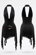 Black halter-neck mini dress shown from both front and back views, featuring a deep plunging neckline, ruched bodice, asymmetrical sheer draped side panels, and two gold-tone decorative accents on the front.